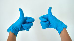 Two gloved hands in a thumbs up