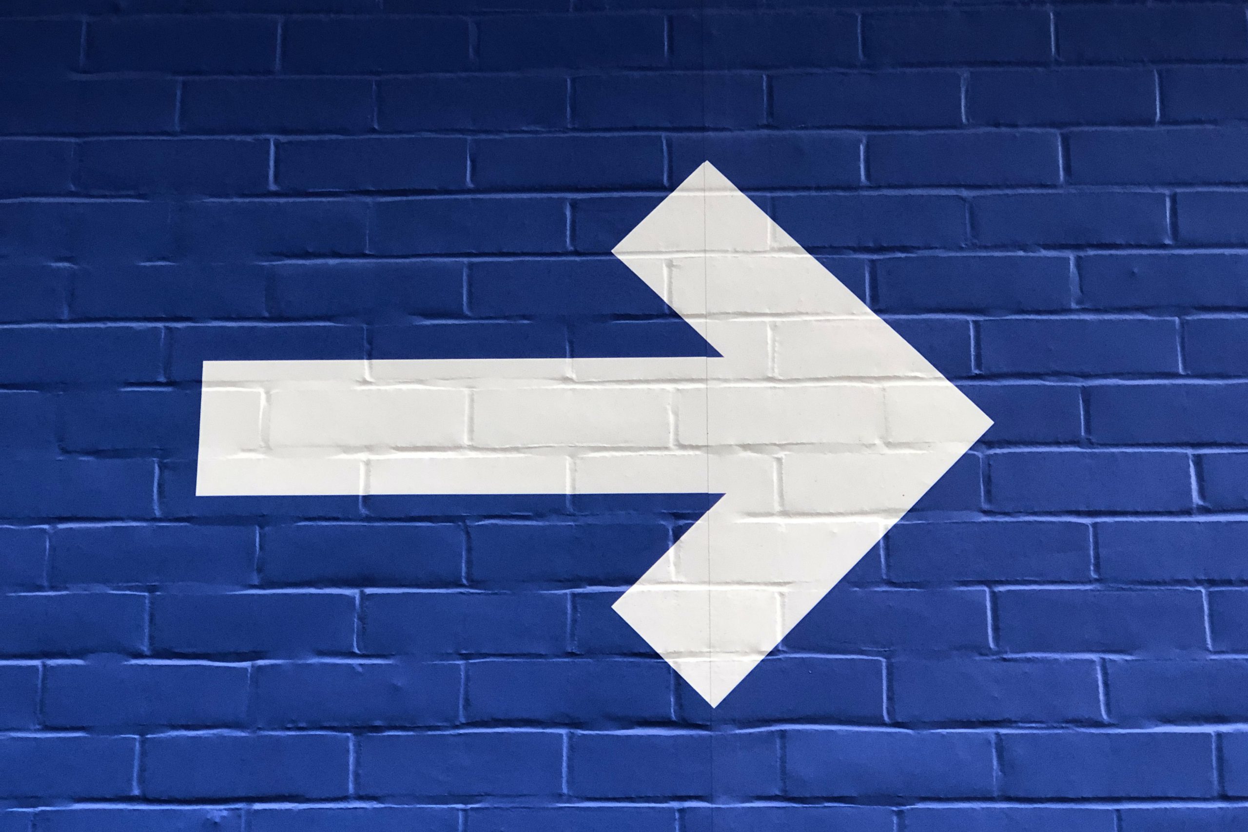 nick-fewings-zF_pTLx_Dkg-unsplash Signage pointing to direction of travel