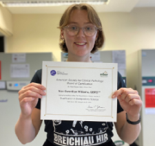 Photograph of Non Williams holding her QBRS certificate